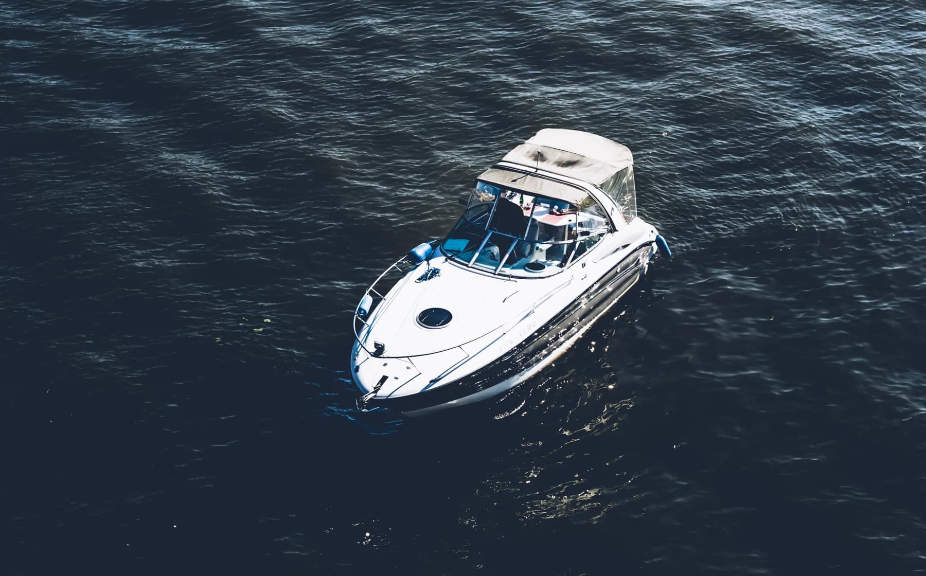 A motorboat on dark open water, seen from above